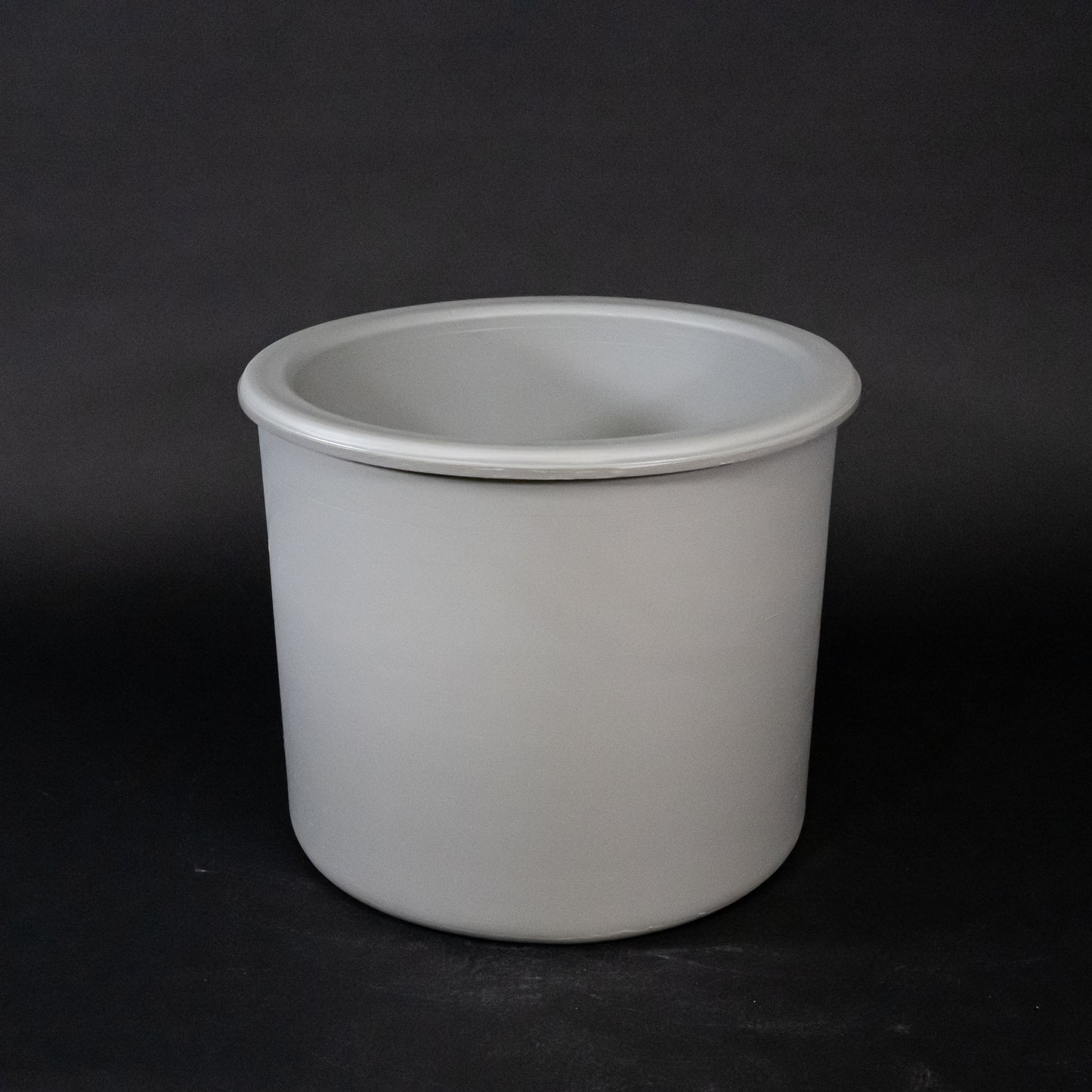 A gray plastic container, suitable for storage and organization purposes.