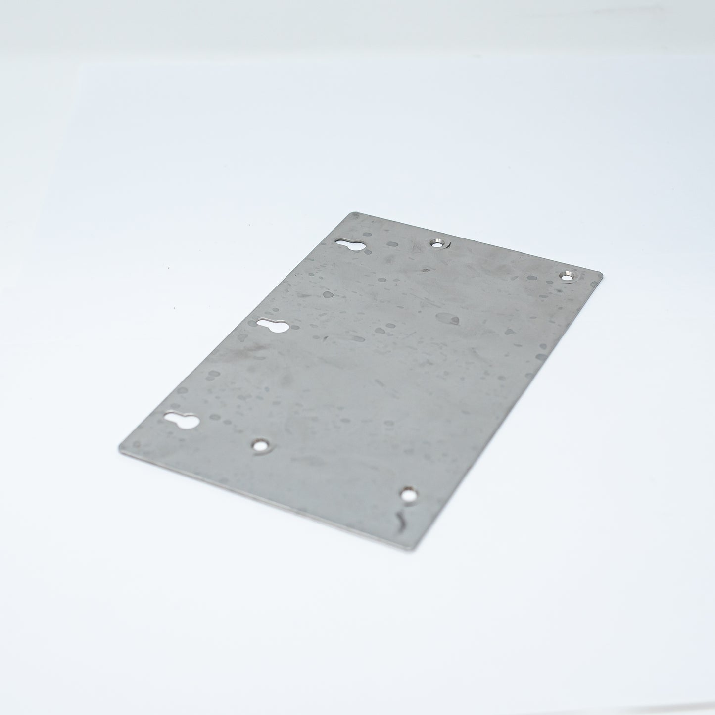 An image of a perforated metal plate, highlighting the arrangement of holes across its flat surface.