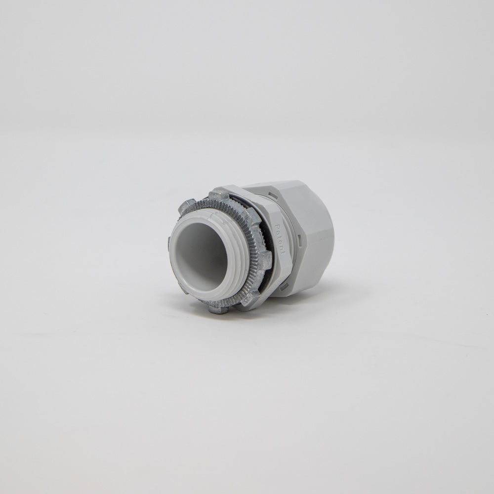 A grey colored plastic connector displayed on a white background, showcasing its clean and unobtrusive design.