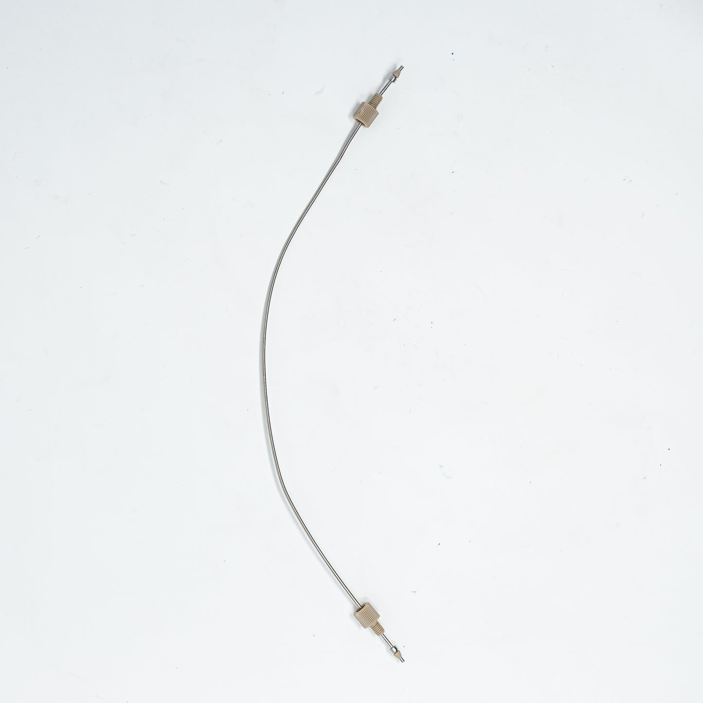 A close-up of stainless steel tubing featuring connectors at each end, showcasing its design and functionality.