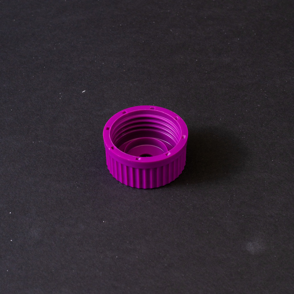 A purple plastic cap featuring a hole, typically used for securing liquid containers.
