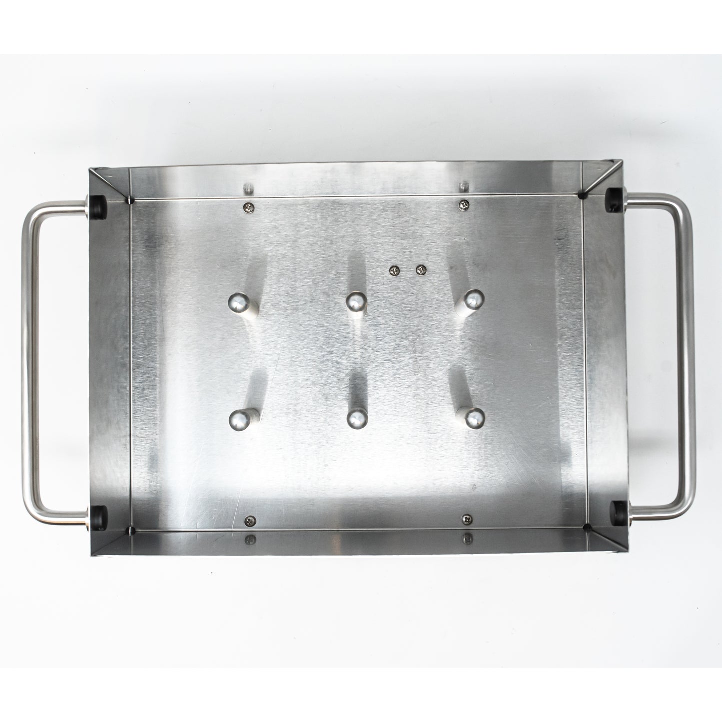 A stainless steel tray featuring four sturdy handles for easy carrying and storage.