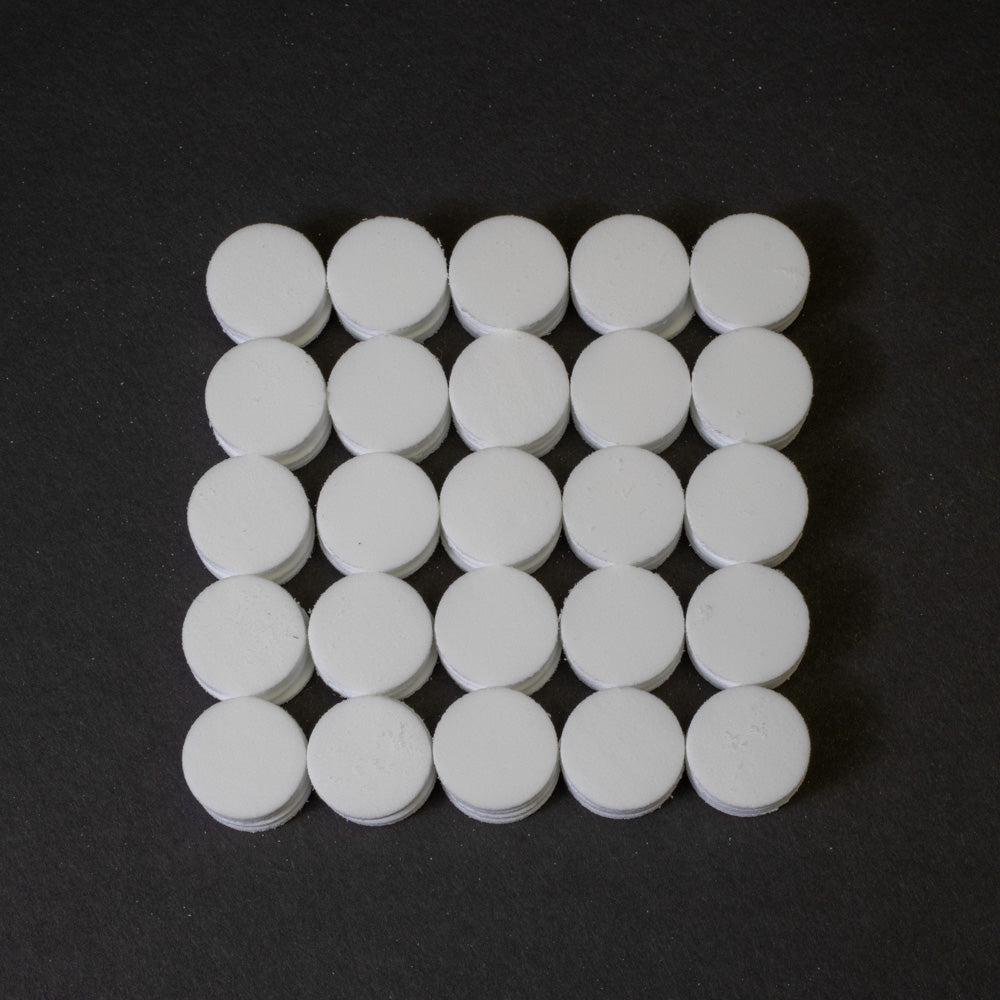 An organized square of white round objects, showcasing a significant quantity in a uniform layout.