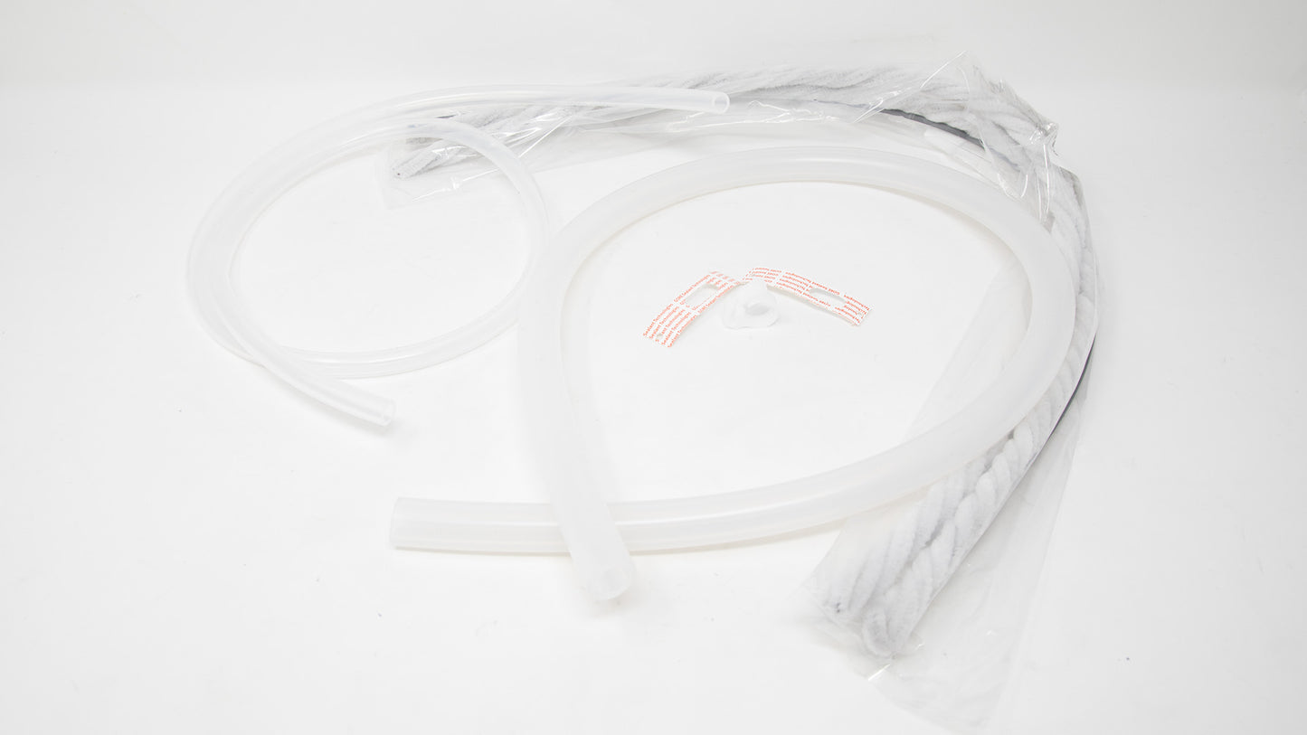 On a white surface, a white hose and a plastic tube are displayed, emphasizing their uniform color and functional design.