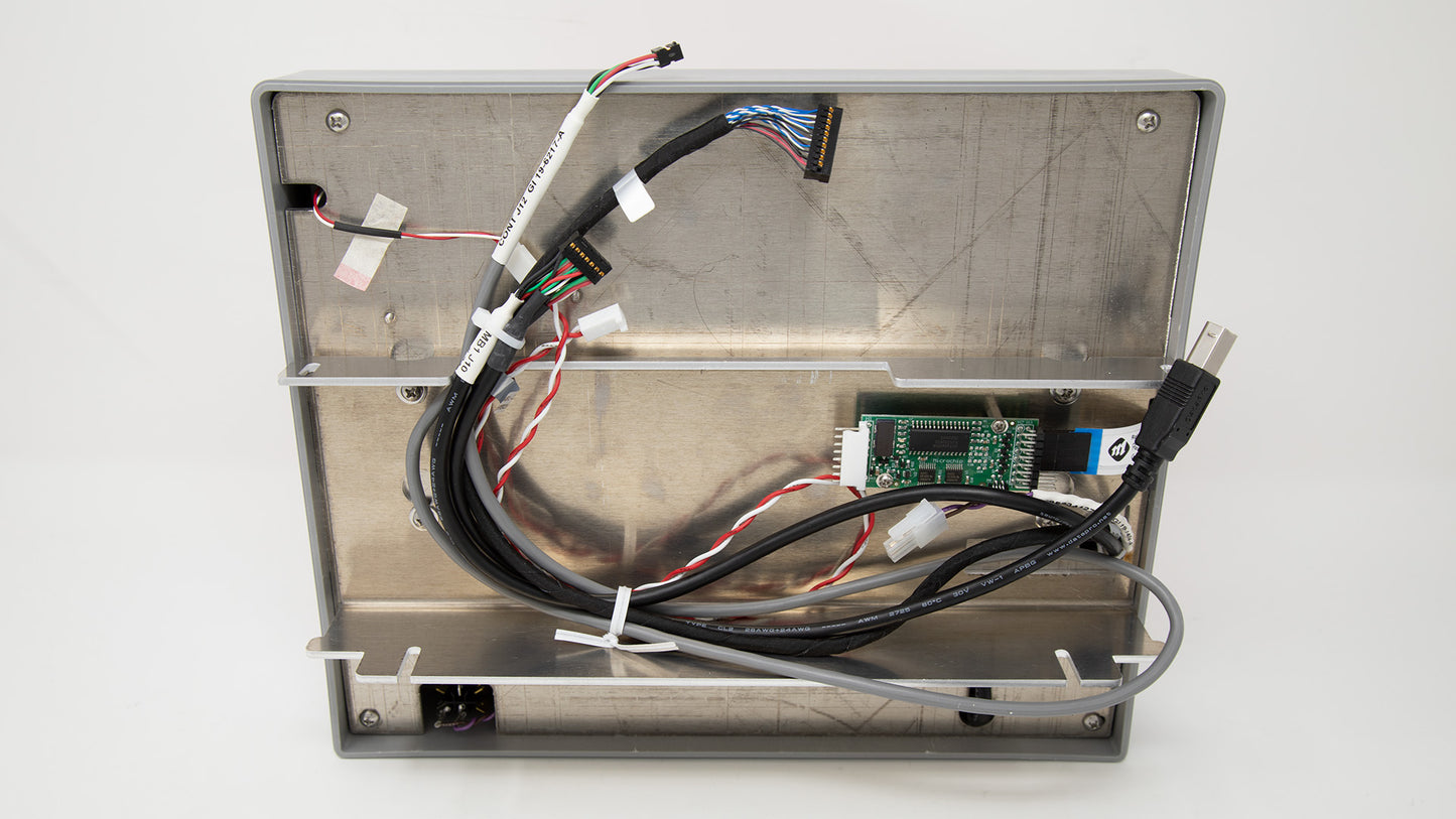 A metallic enclosure featuring multiple wires attached, illustrating a detailed setup of electronic connections.