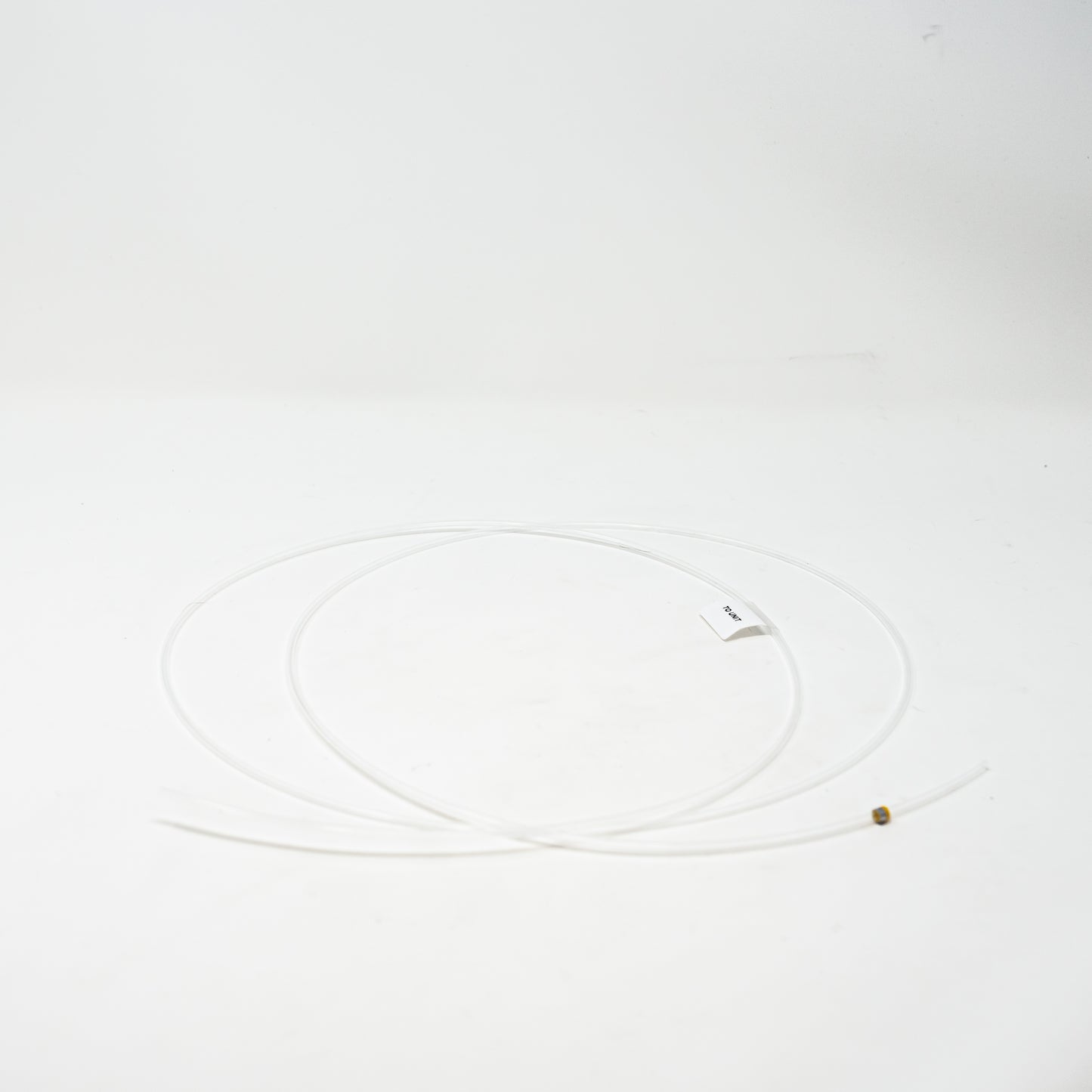 A length of clear tubing arranged neatly on a surface, showcasing their distinct colors and textures.