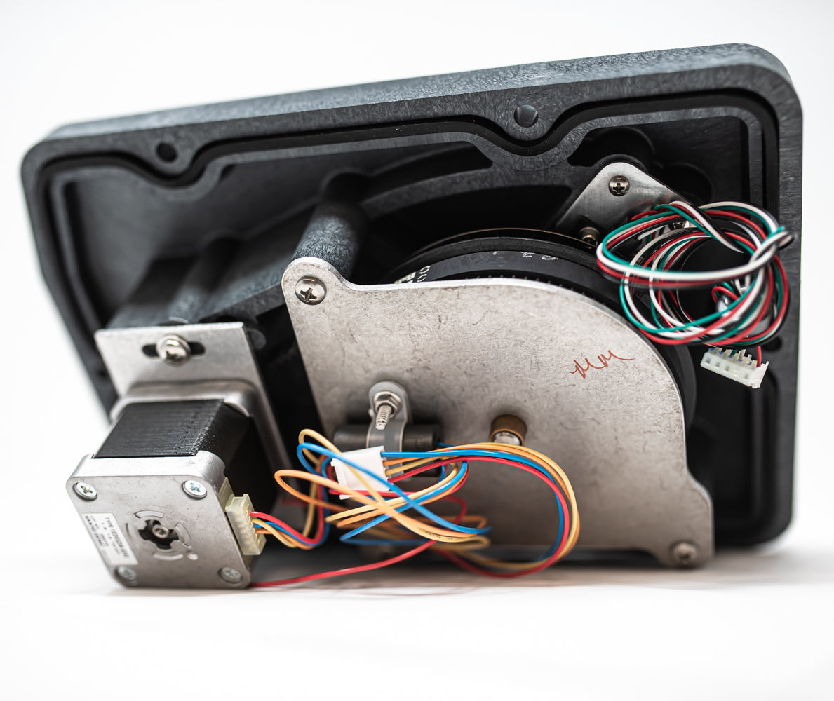 Detailed close-up of a motor with multiple wires attached, showcasing the complexity of its components.