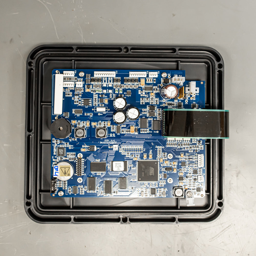A blue electronic board with a compact device, illustrating advanced electronic components and design.