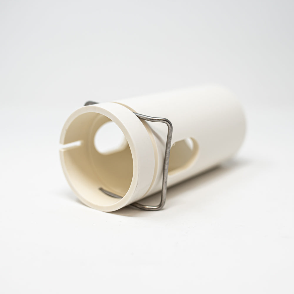 A white plastic cylindrical object with a shiny metal ring, combining simplicity and elegance in its design.
