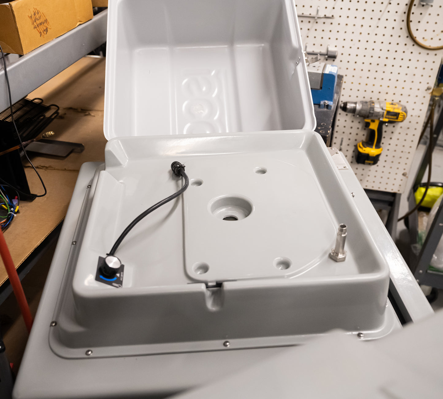 A plastic box featuring a connection cable, emphasizing a clean and organized appearance.