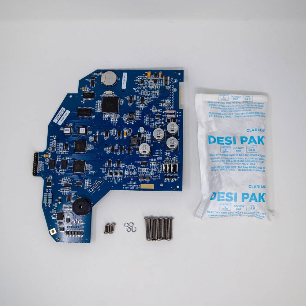 Close-up view of a circuit board, desiccant and mounting hardware, highlighting essential parts for assembly and repair.