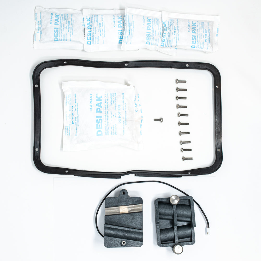 A black plastic cover, wires, and various electronic components arranged neatly.