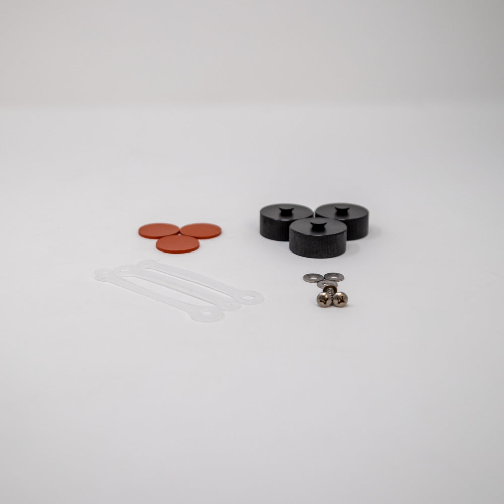 A set of black caps and straps, accompanied by screws, organized on a clean background.