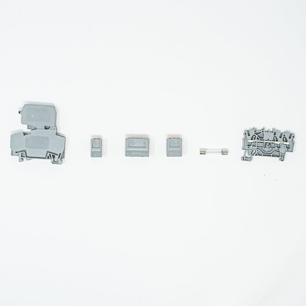 A fuse block and cartridge featuring compact terminal blocks and a fuse, designed for portability and convenience.