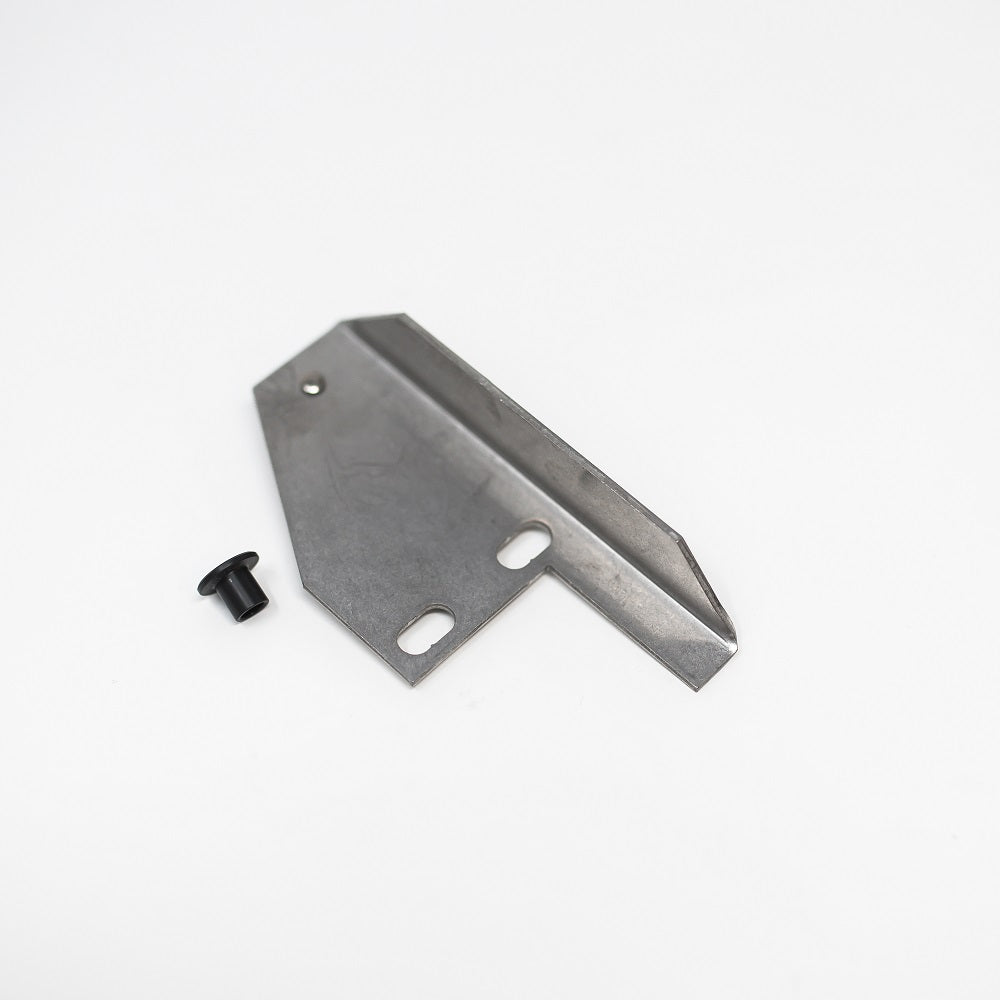 A metal bracket and bushing positioned on a clean white surface, showcasing their design and material texture.