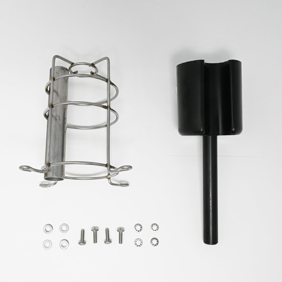 A metal cage with scattered screws and nuts, set against a white surface, showcasing a blend of materials and textures.