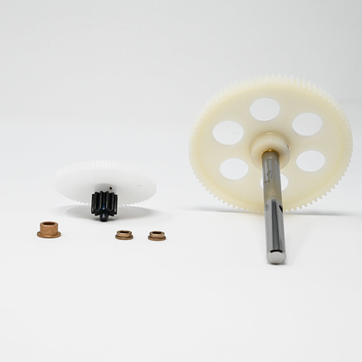 A set of gears positioned on a clean white surface, showcasing their mechanical design and functionality.