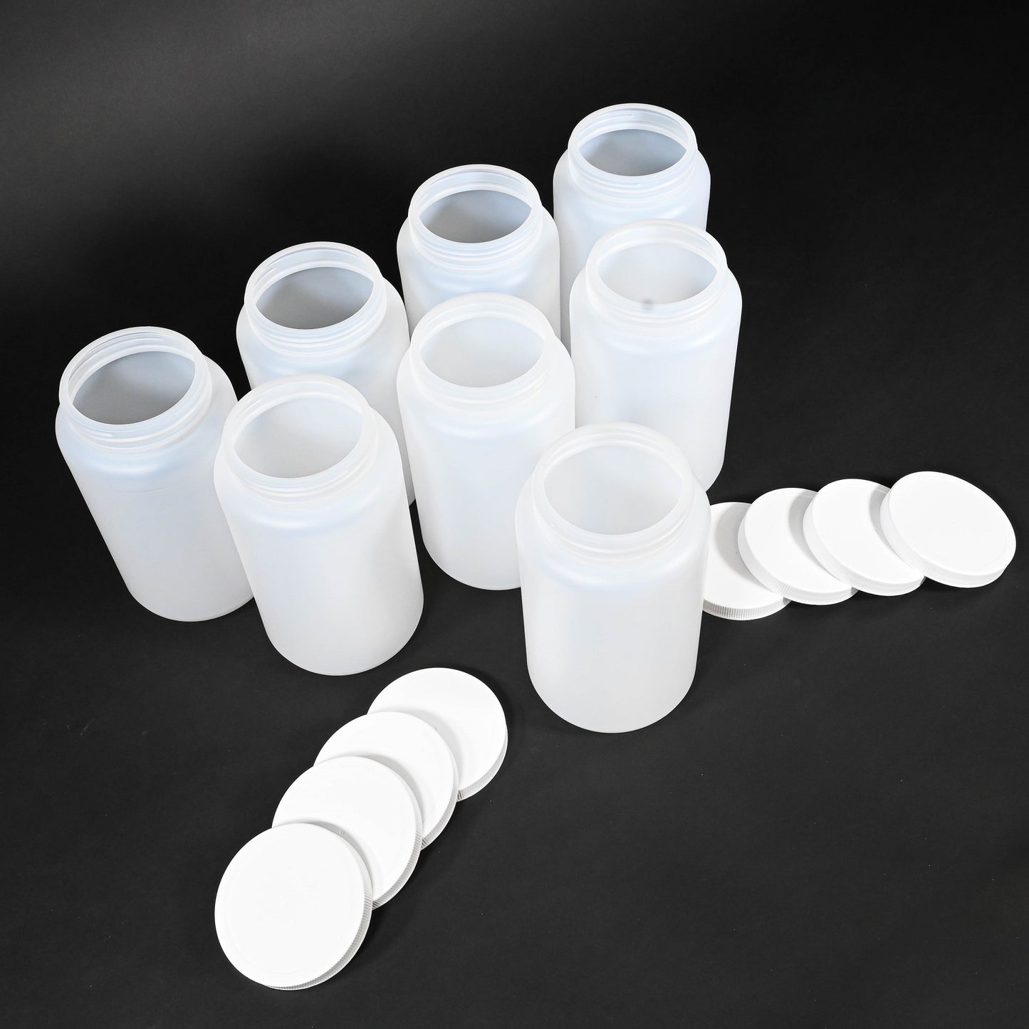 A set of plastic bottles with caps displayed together, showcasing their clear glass design and simple elegance.