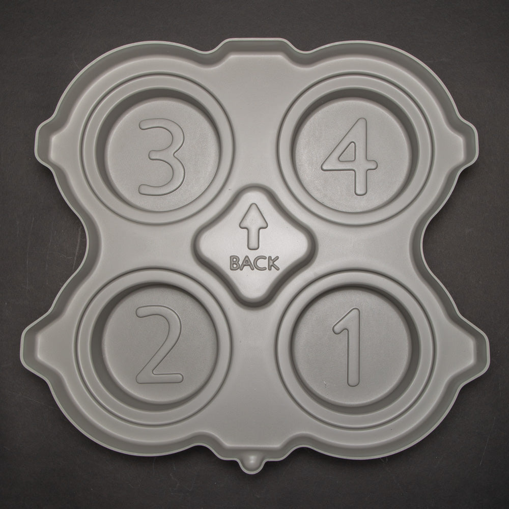 A gray plastic insert featuring four distinct numbers molded into its surface.