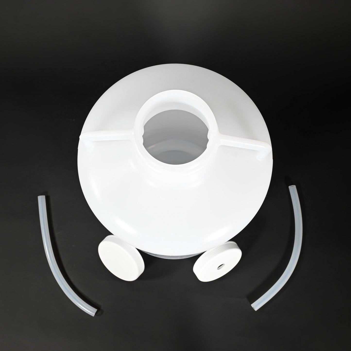 A white plastic container featuring two caps and hoses, suitable for various storage needs.