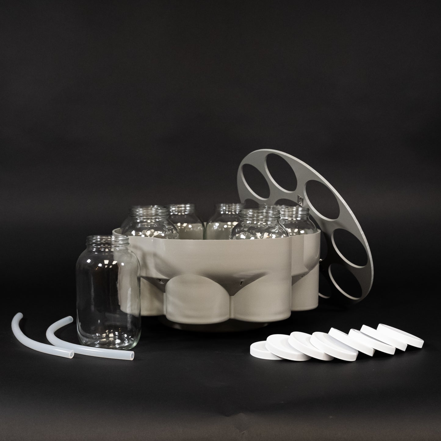 A collection of glass bottles arranged neatly in a tray, showcasing various shapes and sizes.