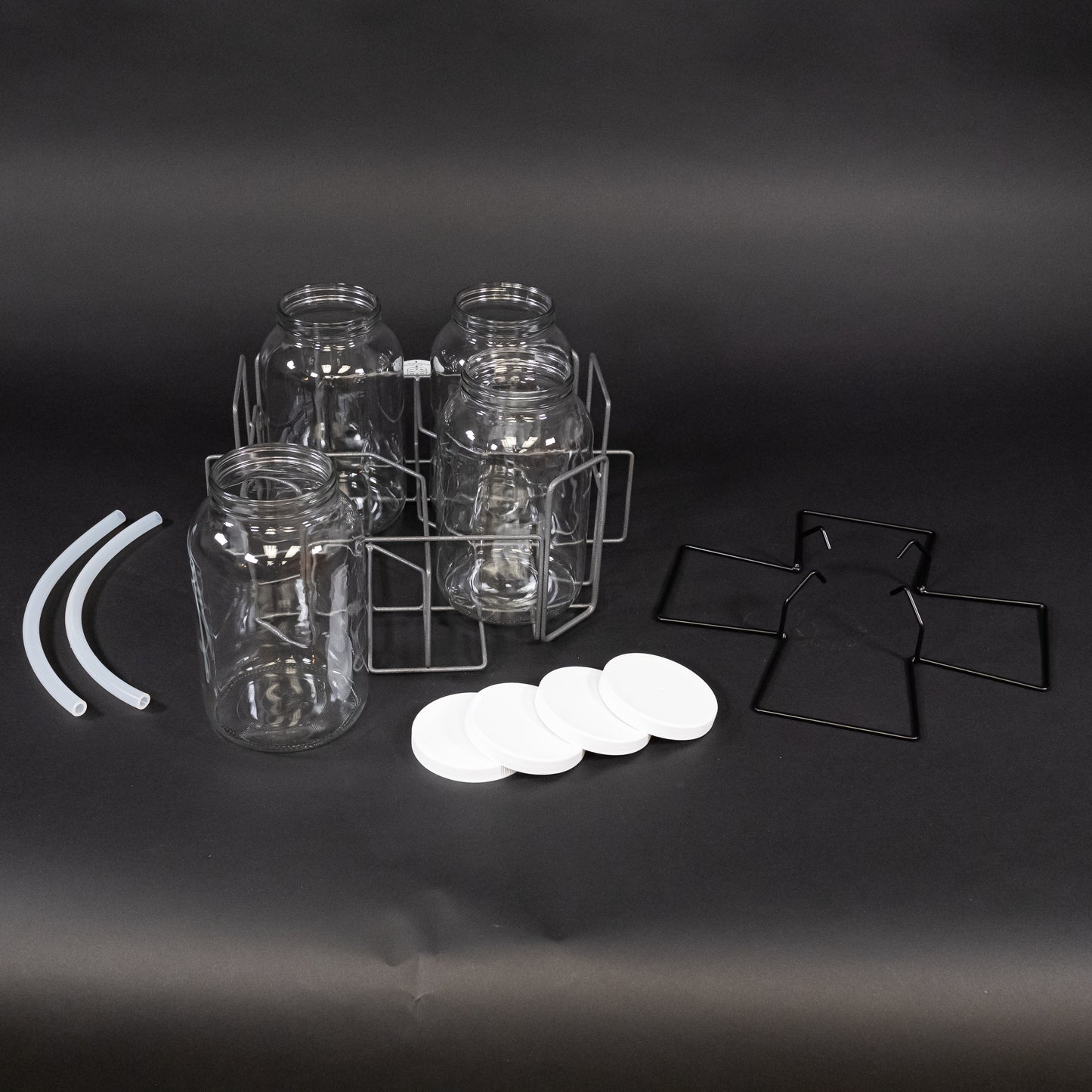 A collection of glass bottles with caps alongside a wire basket, arranged neatly for storage and organization purposes.