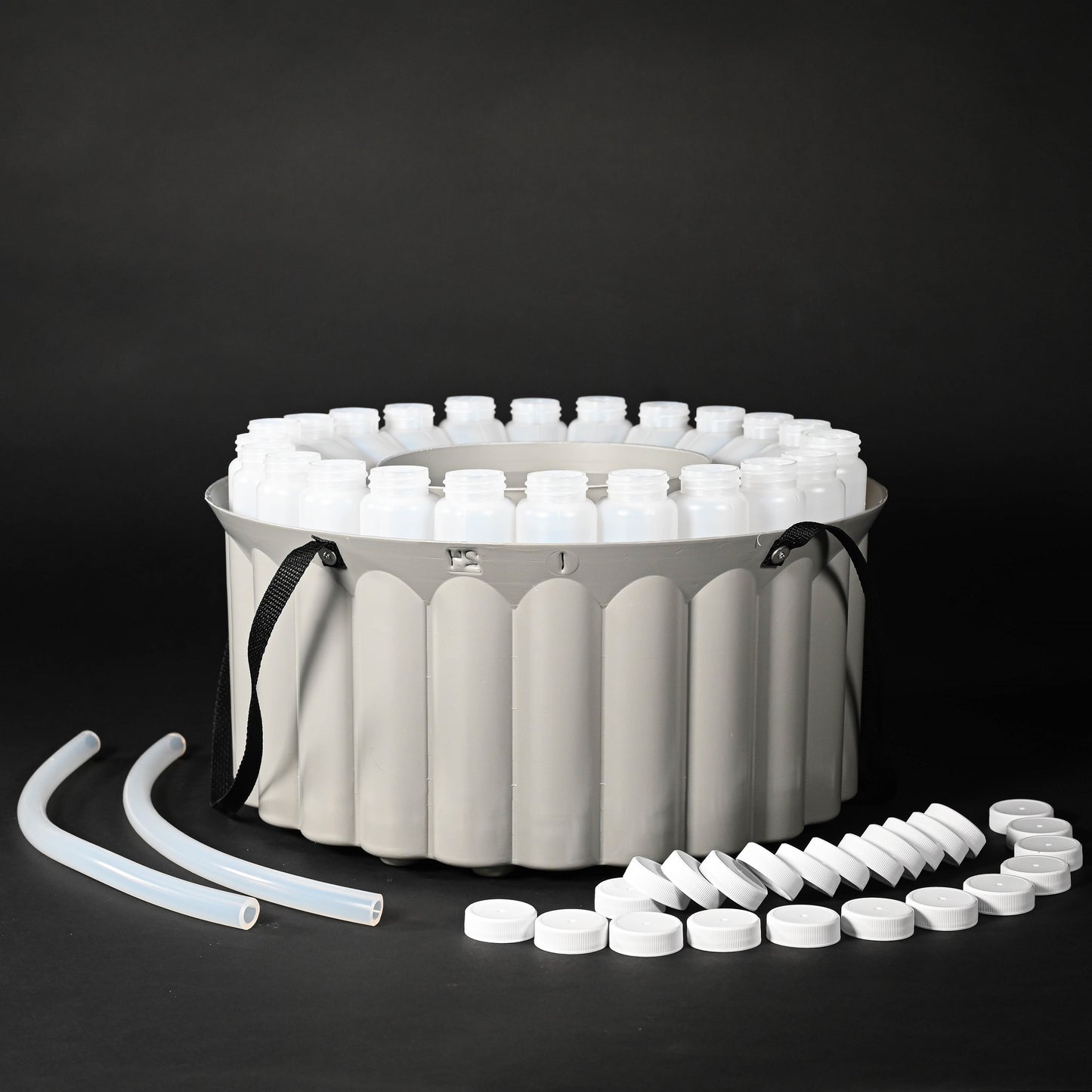 A container with various bottles, caps and tubes, arranged neatly for easy access and organization.