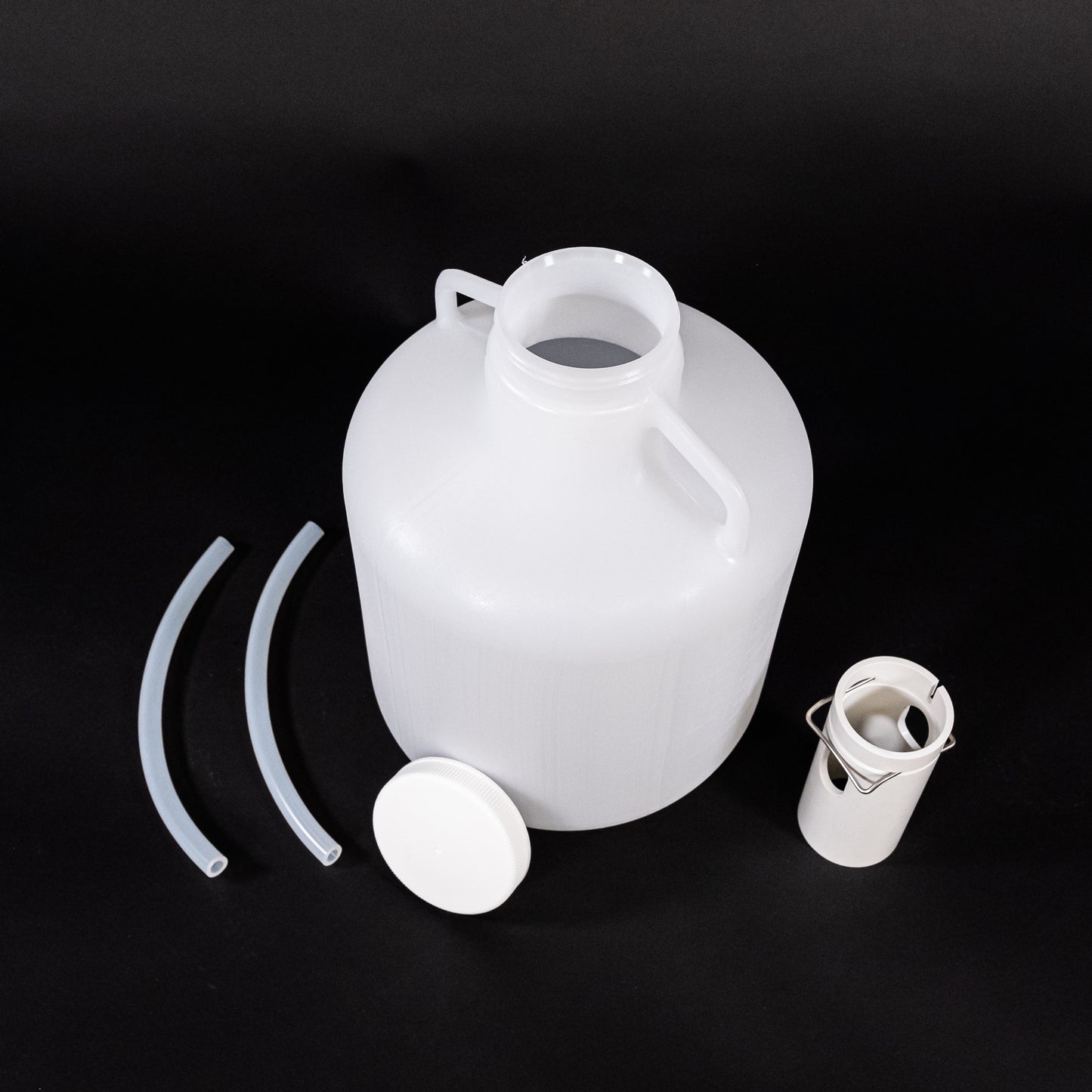 A plastic jug with lids and hoses and plastic tube, designed for efficient liquid storage.
