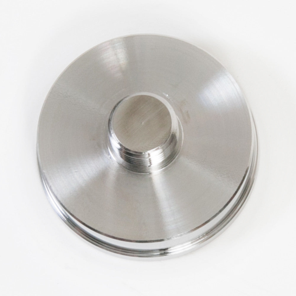 A round metallic item with a central opening, displaying a sleek surface and a minimalist aesthetic.