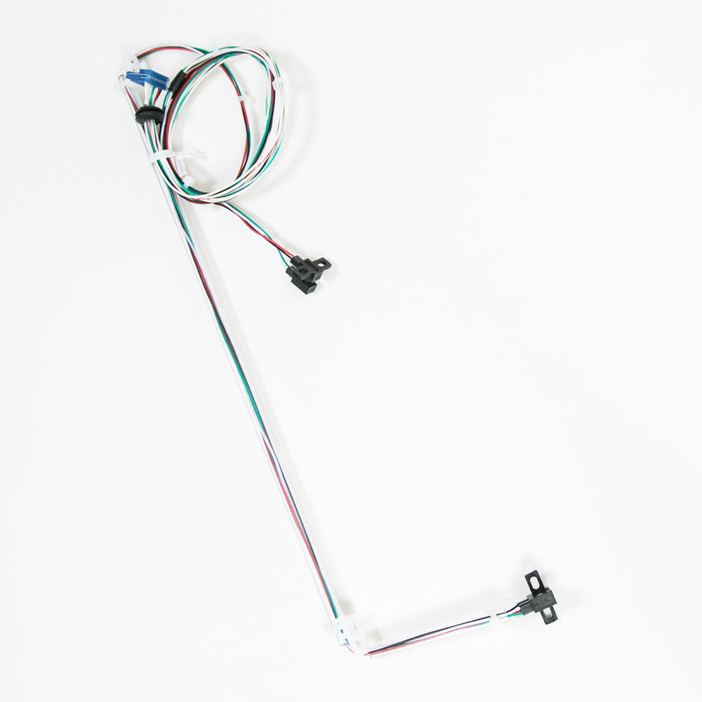 A group of wires displayed on a white surface, illustrating a simple electrical connection.