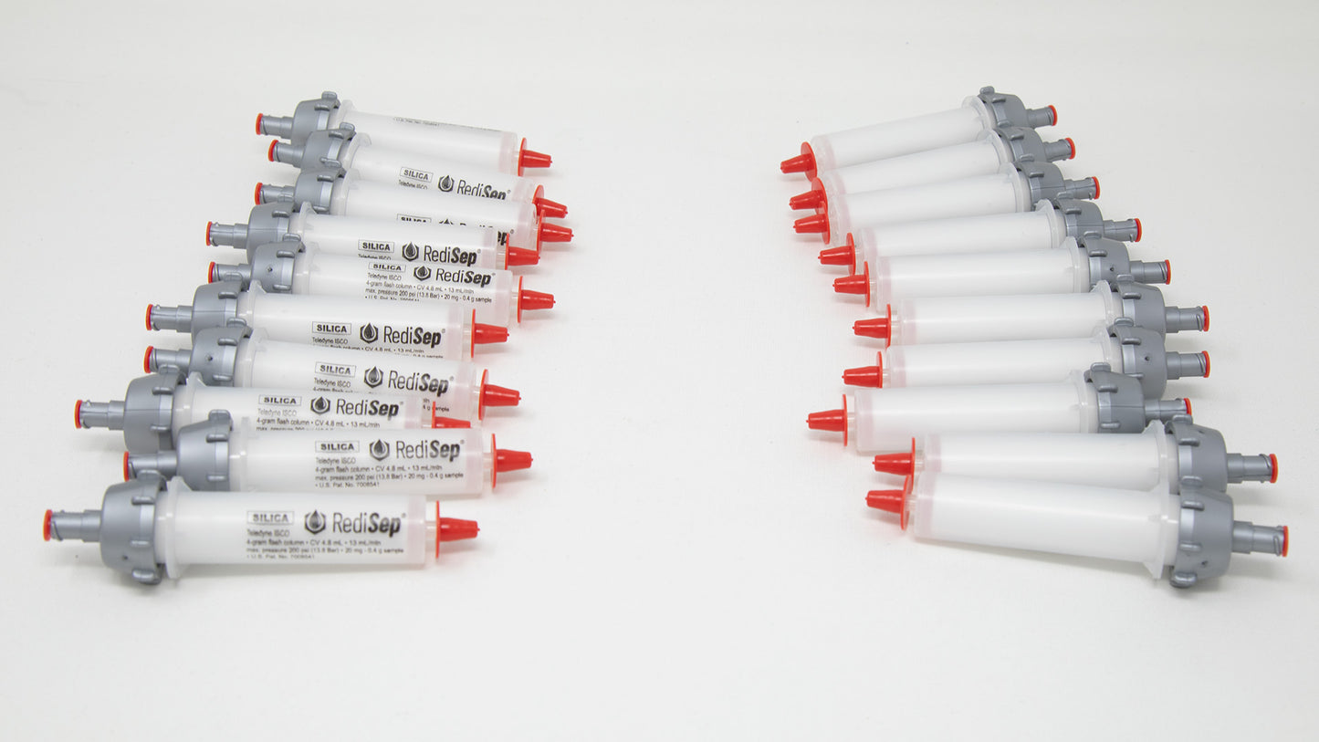 A group of plastic tubes with red and silver caps, positioned side by side, emphasizing their contrasting colors and forms.