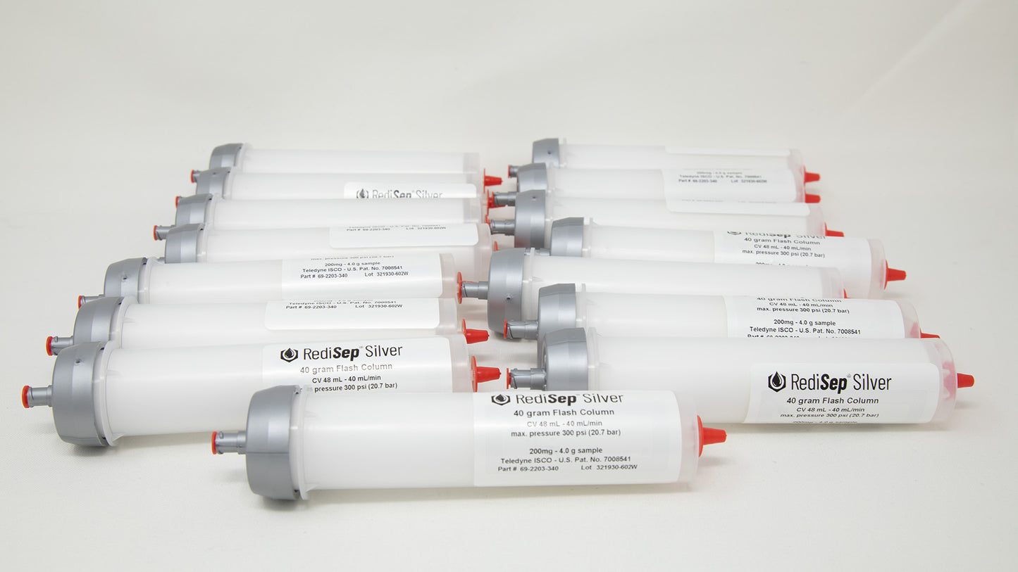 A group of plastic tubes with red and silver caps, positioned side by side, emphasizing their contrasting colors and forms.