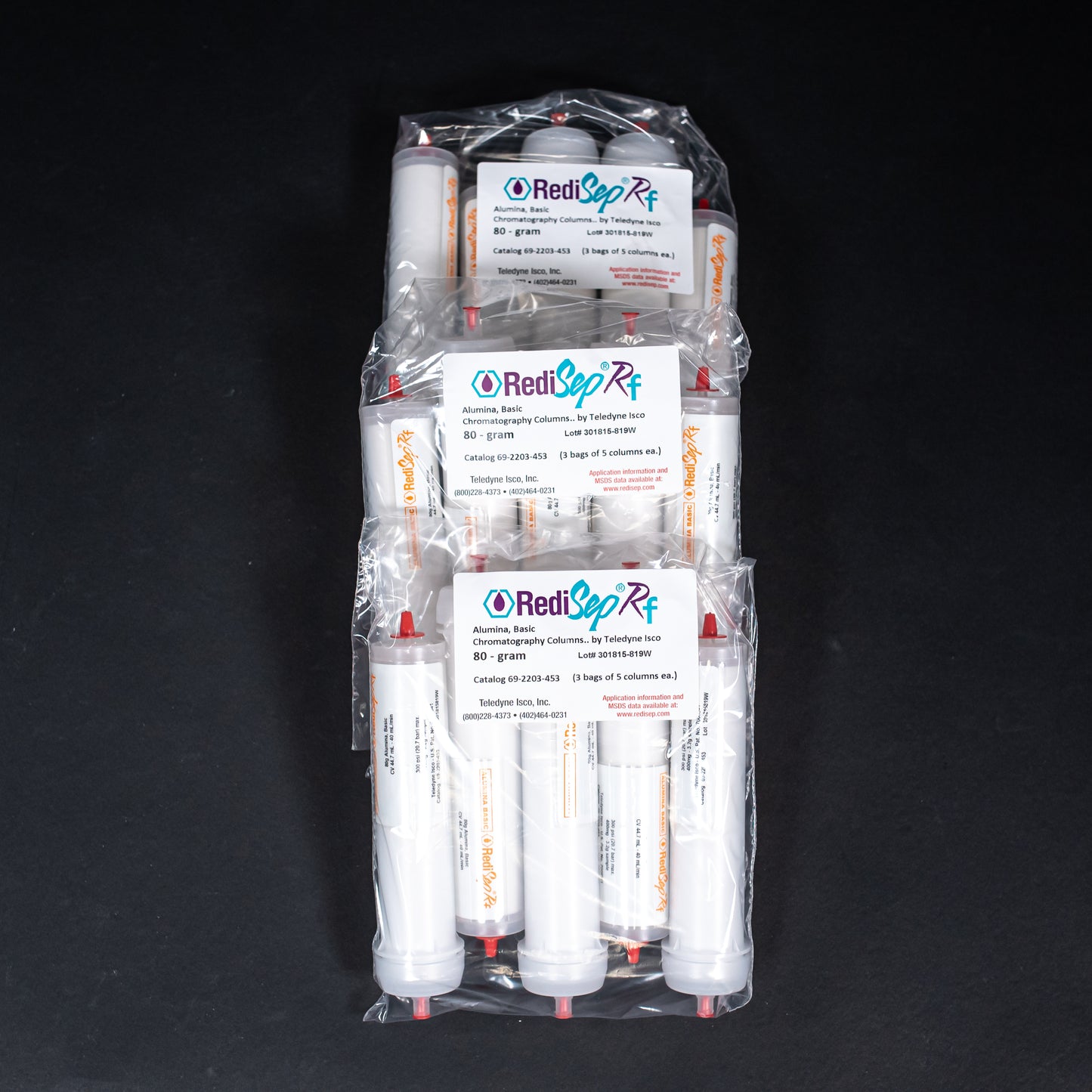 A set of white tubes featuring prominent red caps, showcasing a simple yet striking design.