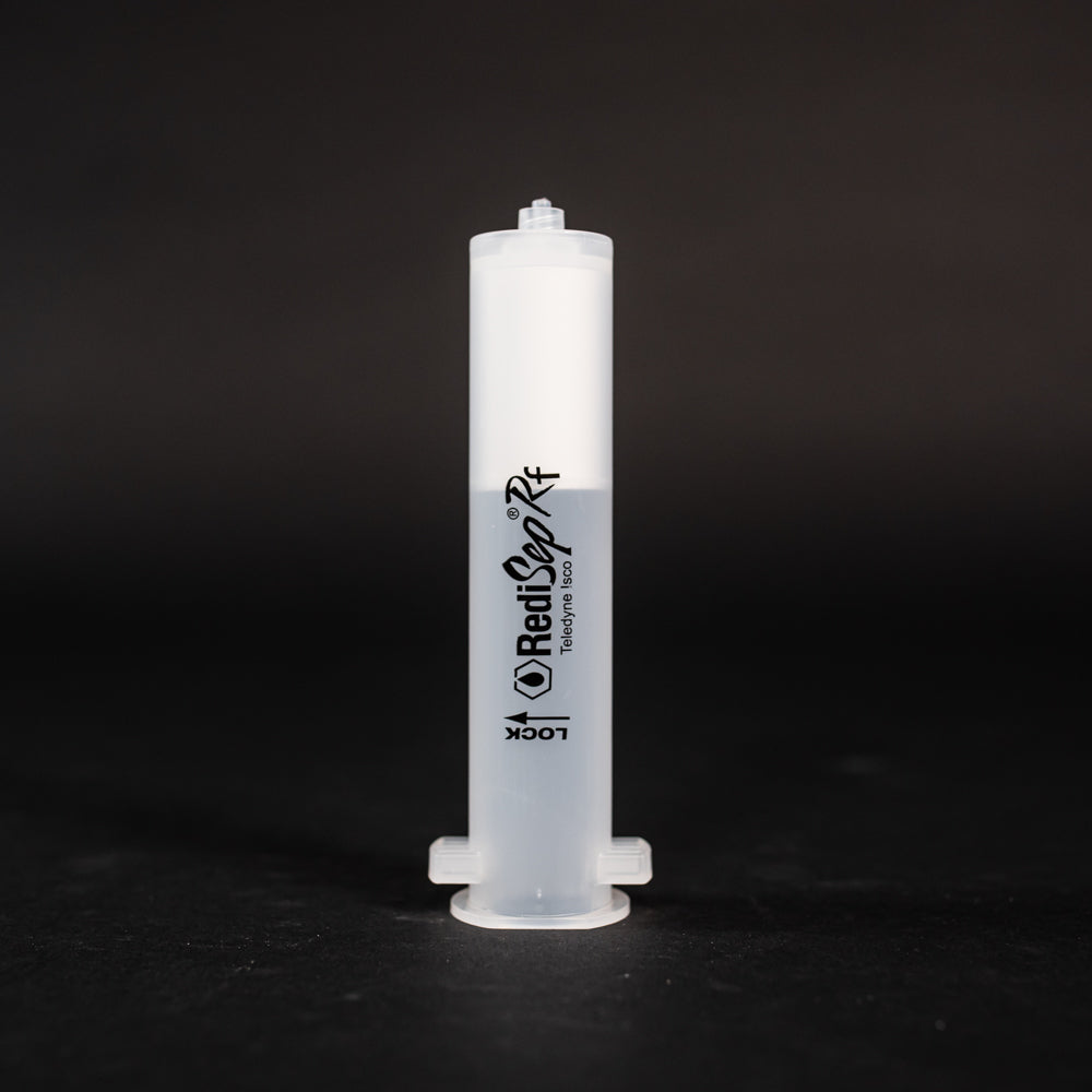 A white plastic cylindrical shaped object placed on a sleek black surface, creating a striking contrast between the two colors.