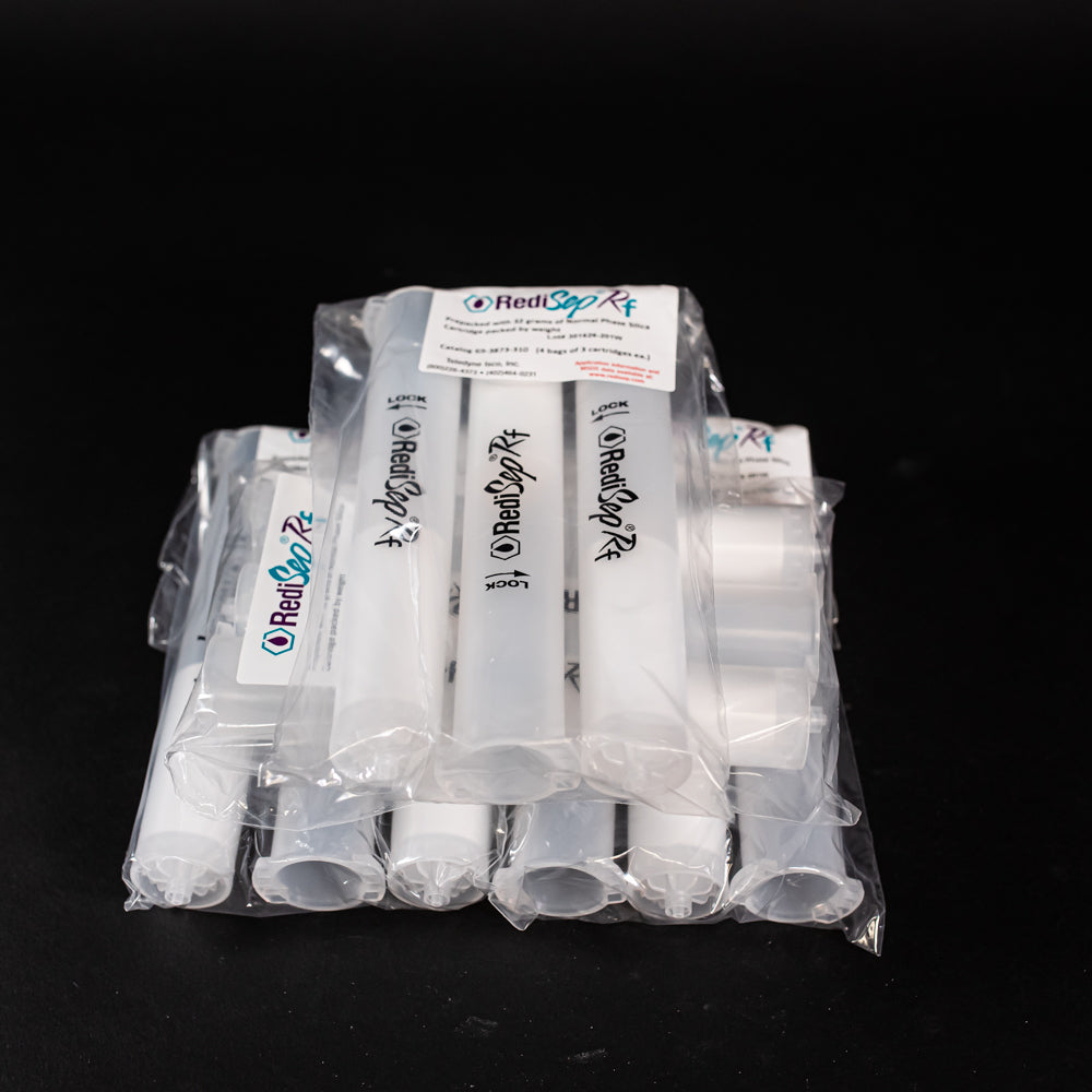 A set of white plastic cylindrical shaped objects placed on a sleek black surface, creating a striking contrast between the two colors.