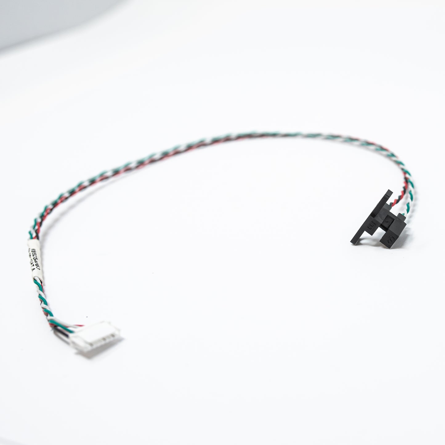 A detailed view of a cable with a small black wire and a red wire, emphasizing the color differentiation between the two.