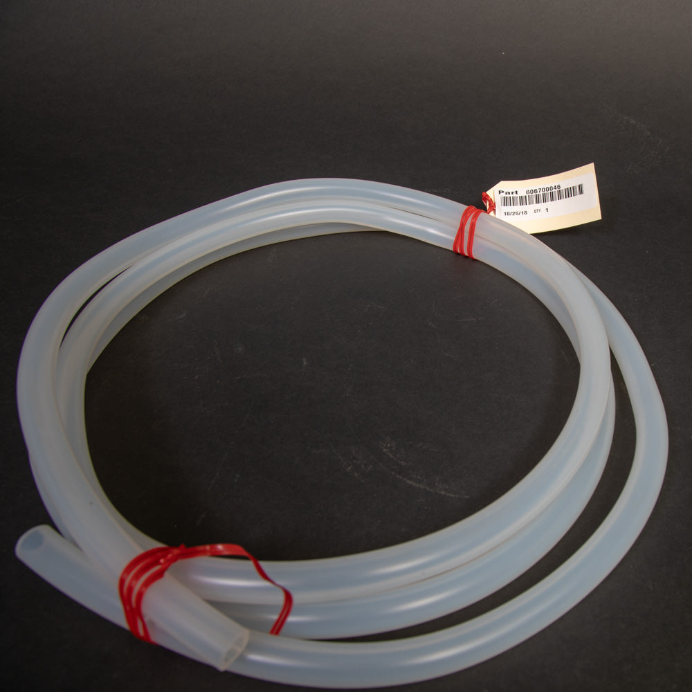 A roll of silicone rubber tubing coiled on a surface, featuring several red tags attached along its length.
