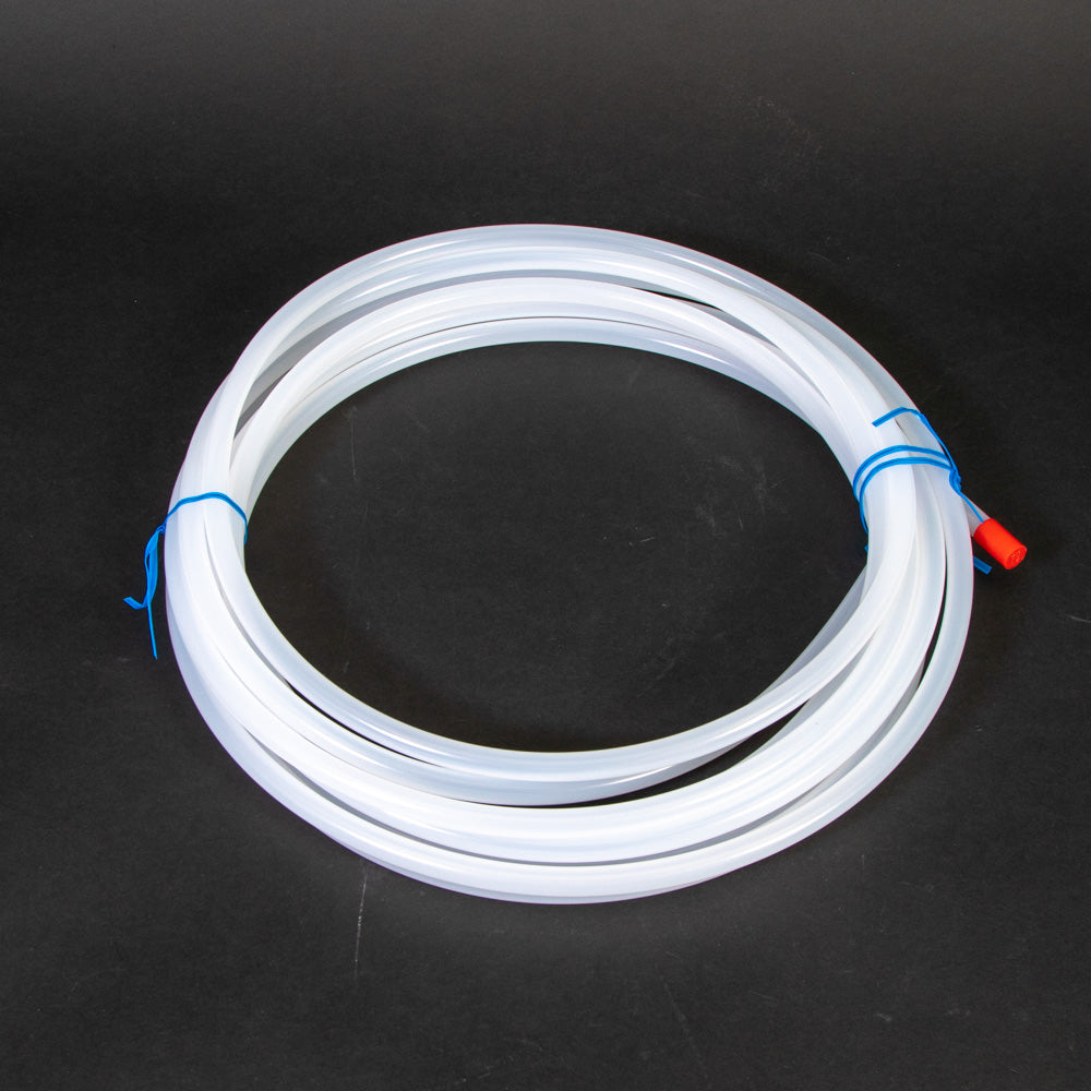 A coiled white hose, positioned on a flat surface.