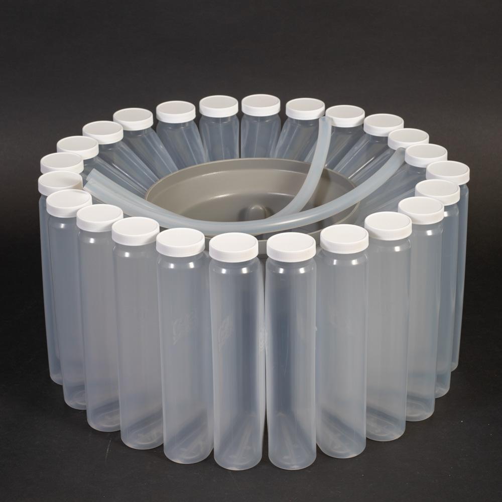 A circular formation of wedge shaped plastic bottles with caps, evenly spaced, highlighting their transparent surfaces and uniform shape.