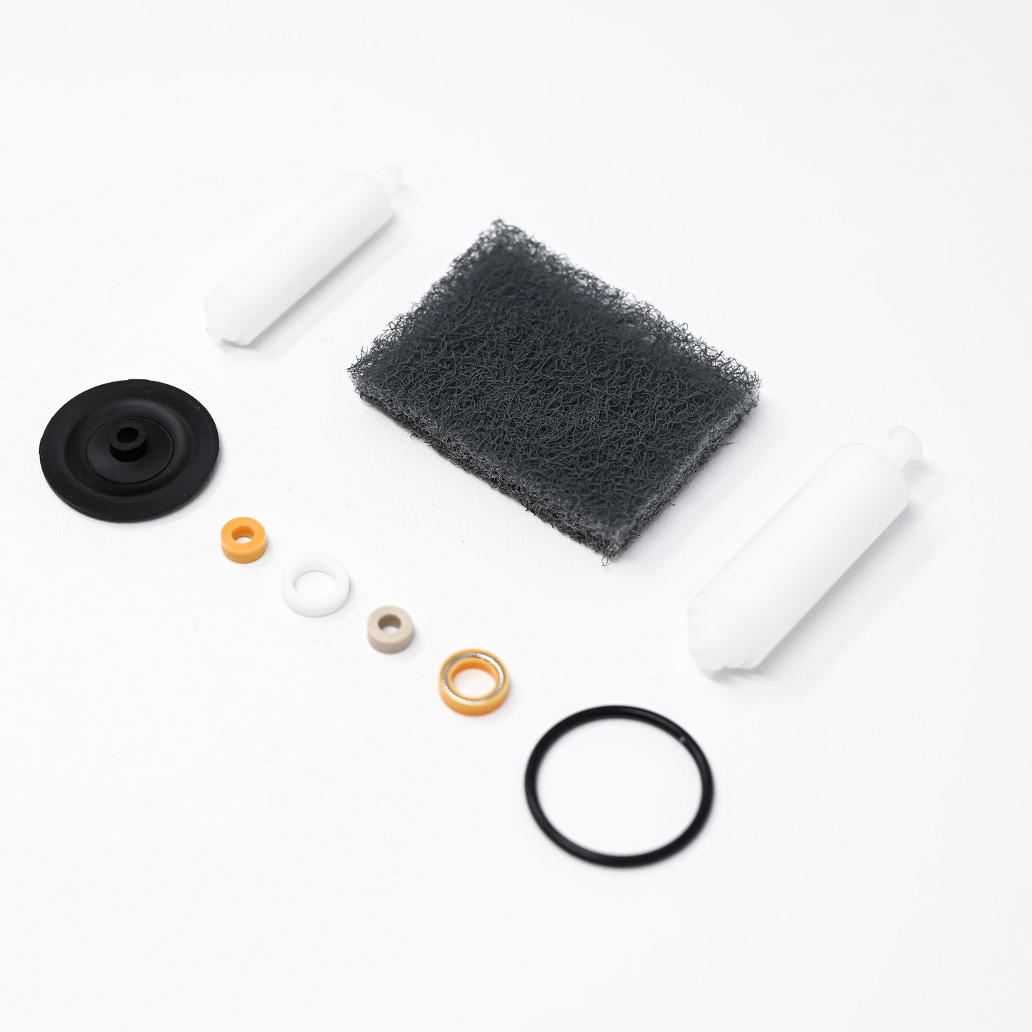 A collection of parts including seals, washers, bushings, o-rings, removal tools and scour pad.