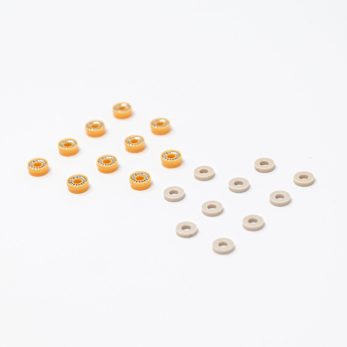 A collection of orange and white plastic seals arranged neatly on a surface, showcasing their vibrant colors and shapes.