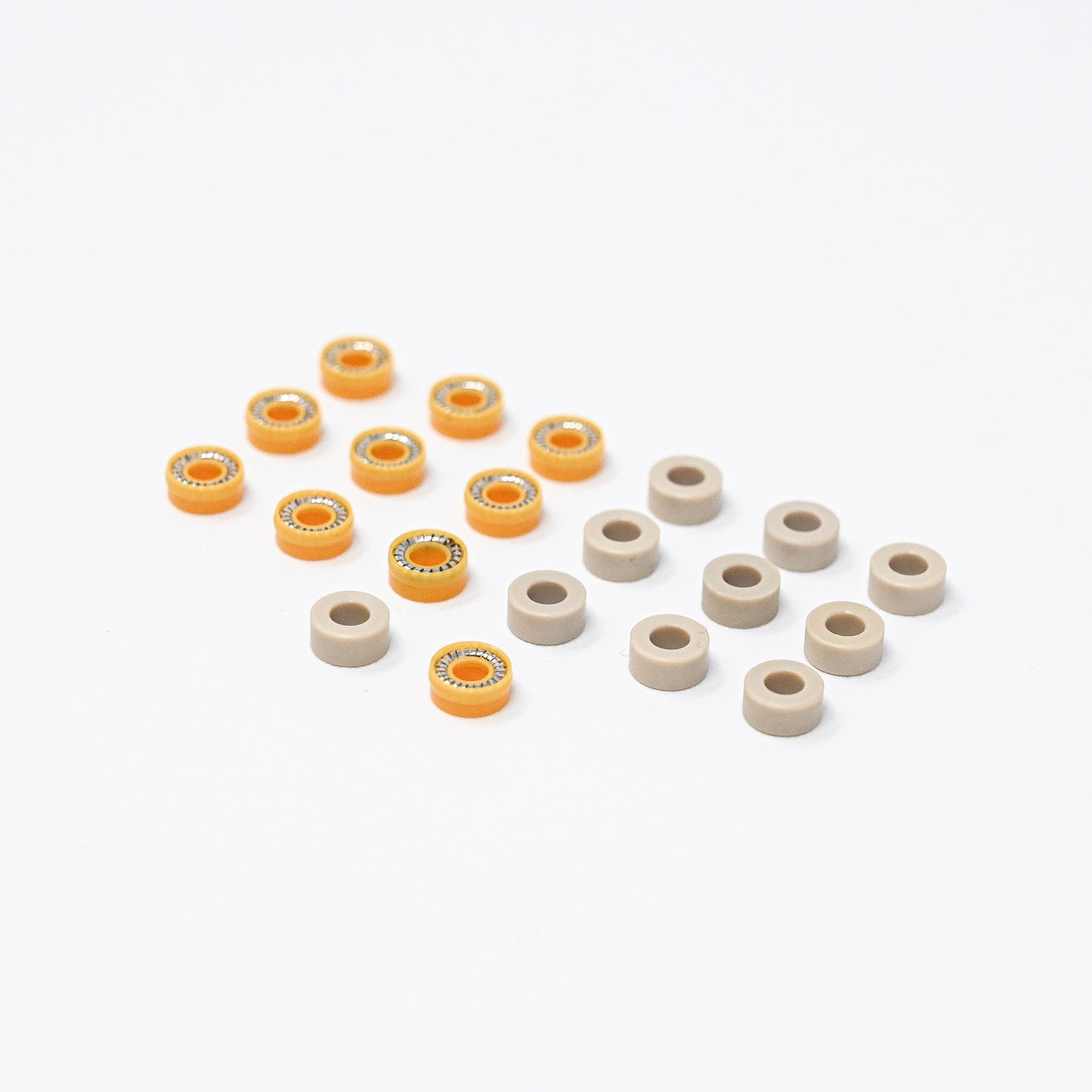A collection of orange and white plastic seals arranged neatly on a surface, showcasing their vibrant colors and shapes.