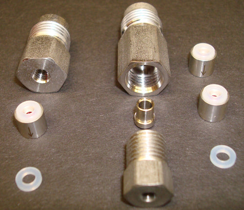 An assortment of stainless steel fittings and check valves, including a threaded fitting, emphasizing quality and precision in design.