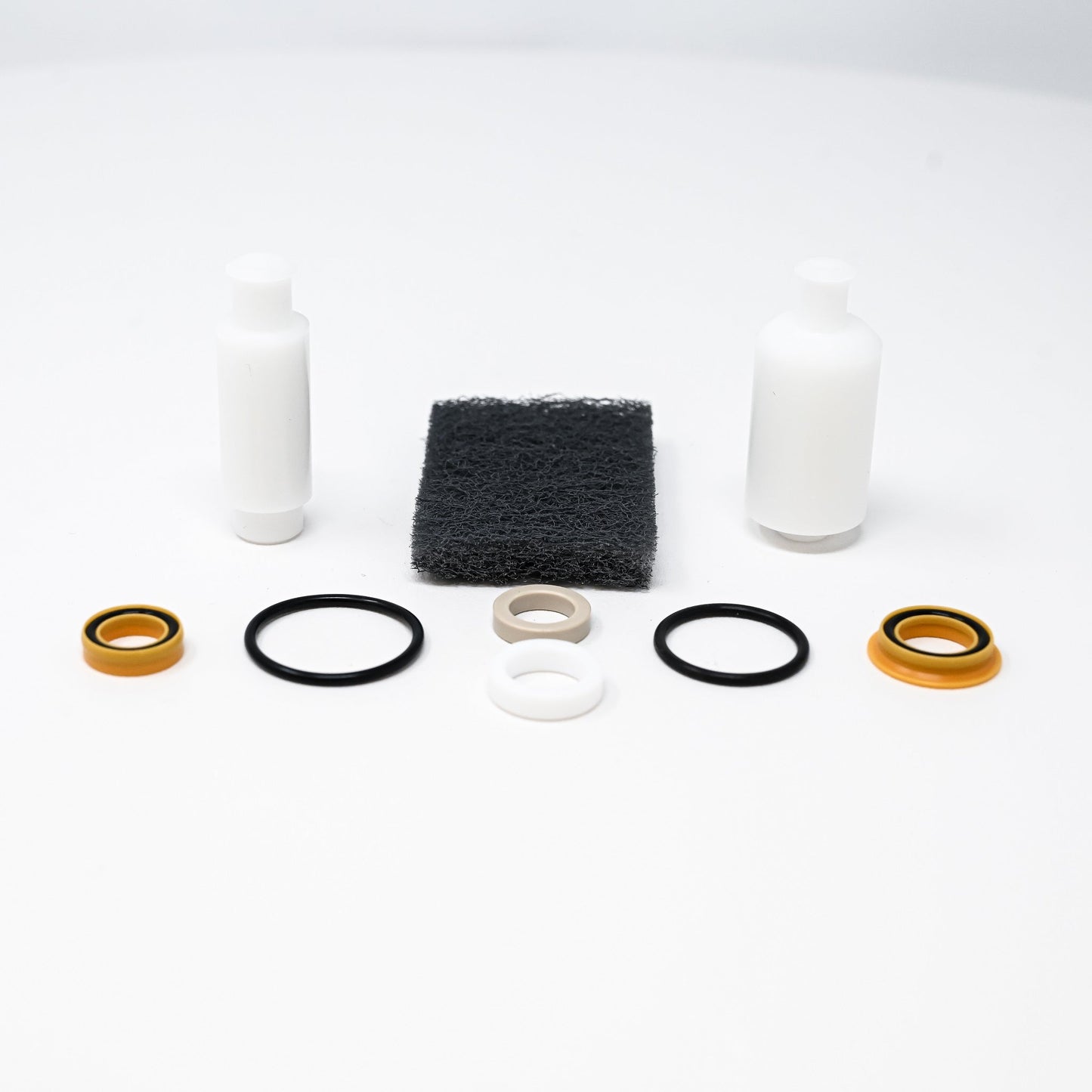 A collection of pump components arranged neatly, showcasing various parts essential for assembly and repair.