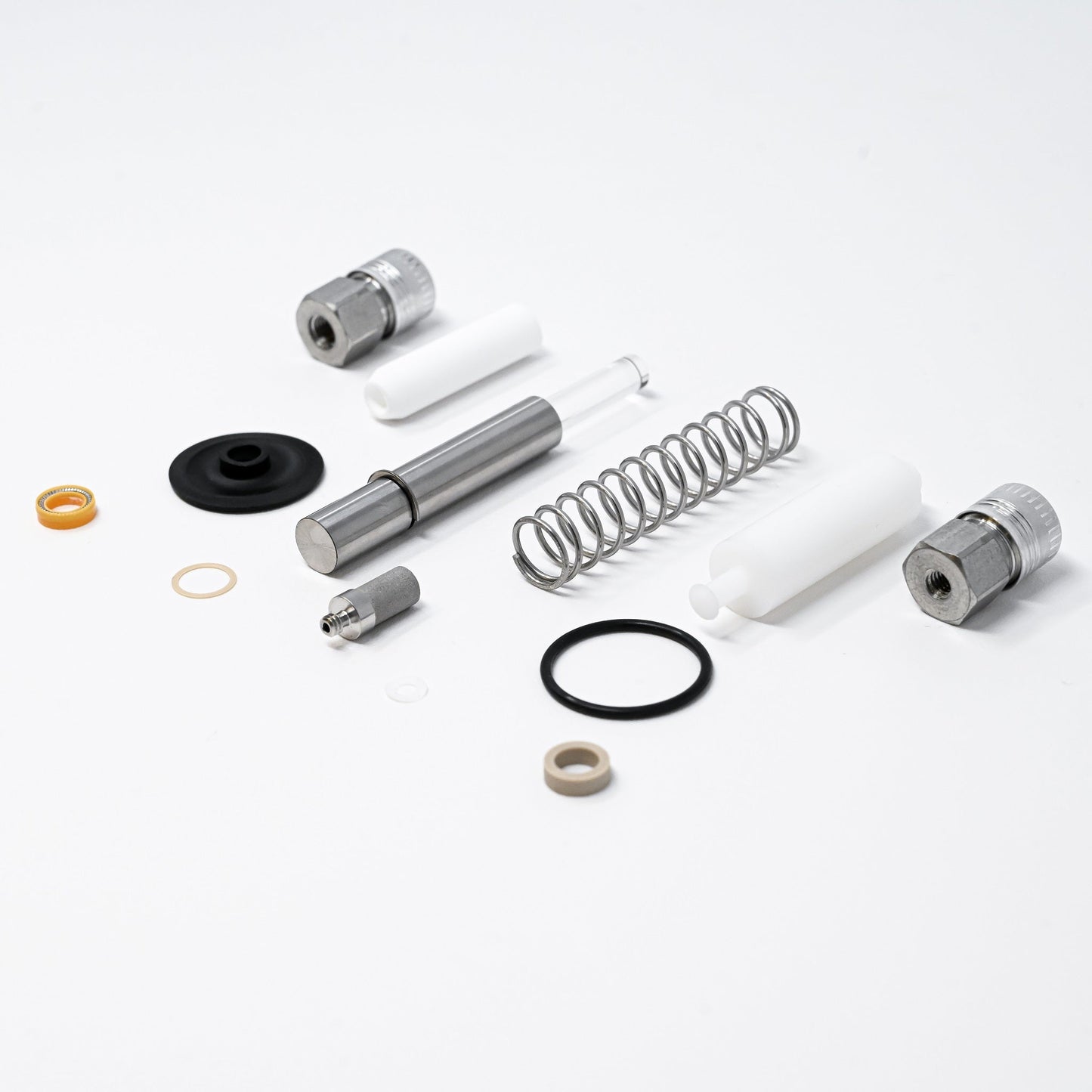 A collection of pump components arranged neatly, showcasing various parts essential for assembly and repair.