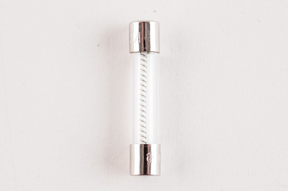 An electronic fuse placed on a clean white surface, emphasizing its sleek design.