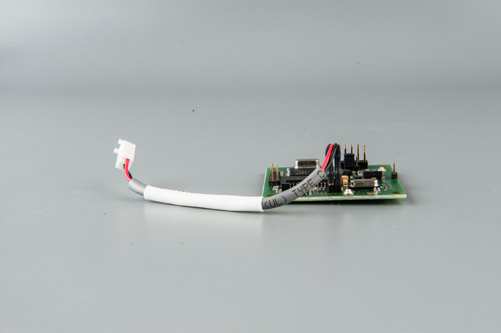 A small electronic device with multiple wires connected, showcasing its compact design and intricate wiring.