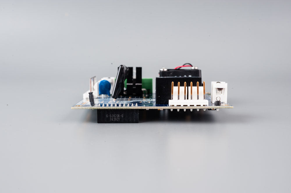 A compact electronic board displaying a barcode for identification purposes.