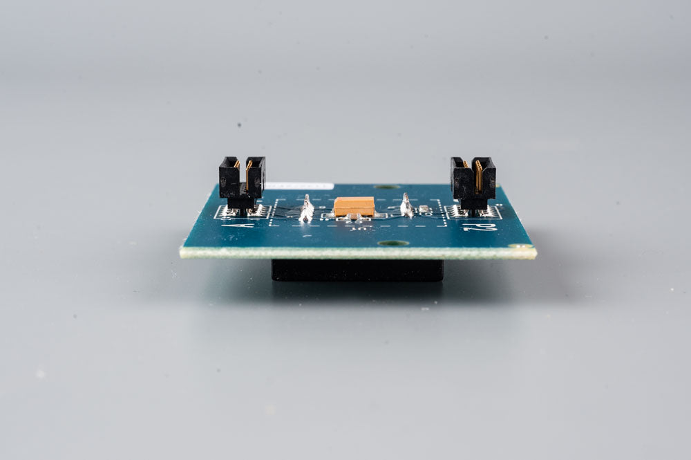 A small electronic device with a detailed circuit board, highlighting its intricate design and electronic components.