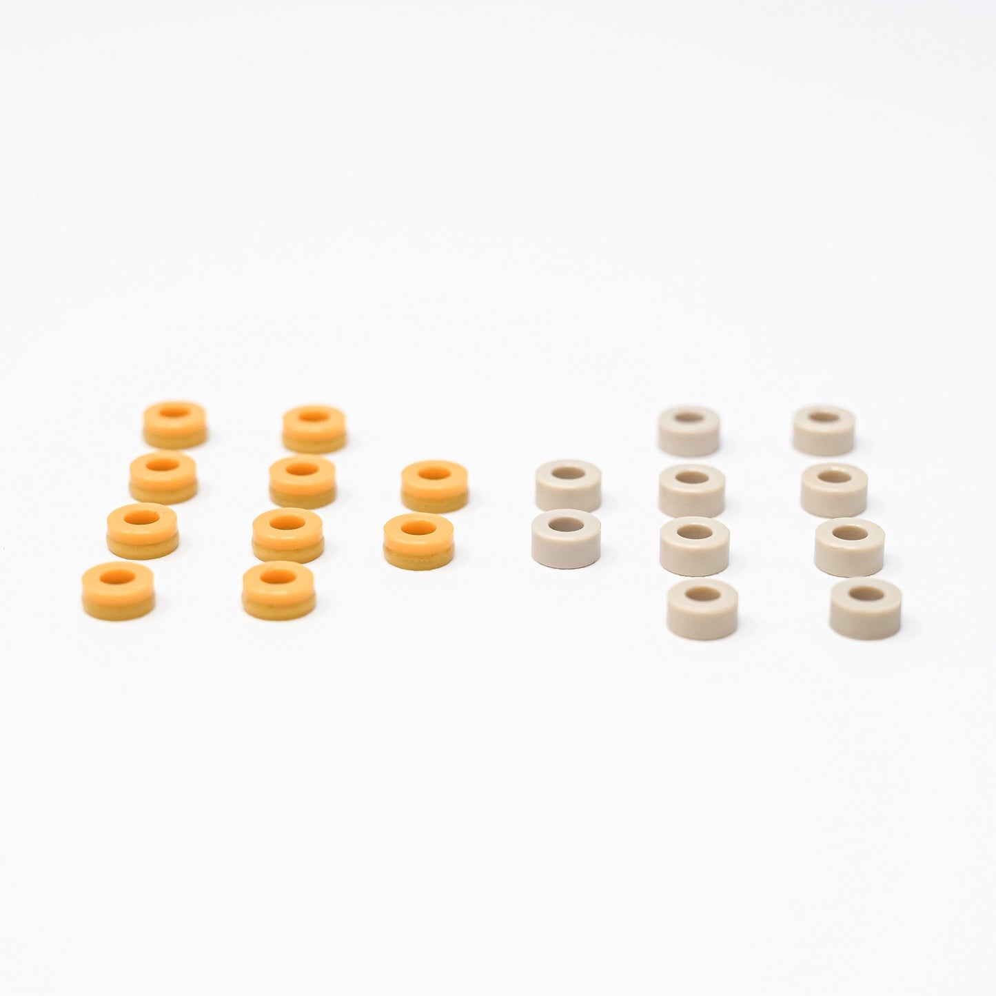 A collection of orange and white plastic seals arranged neatly on a surface, showcasing their vibrant colors and shapes.
